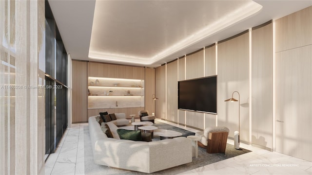 cinema room with a raised ceiling and light tile floors