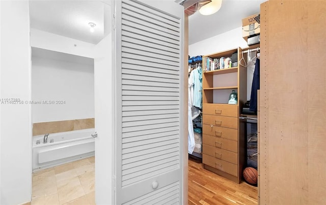 walk in closet featuring light tile flooring