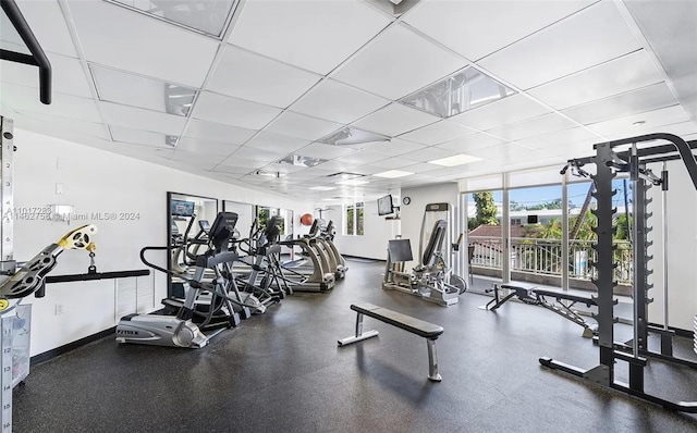 exercise room with a paneled ceiling