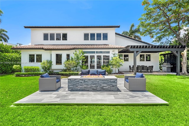 back of house featuring a patio, french doors, an outdoor living space with a fire pit, and a lawn