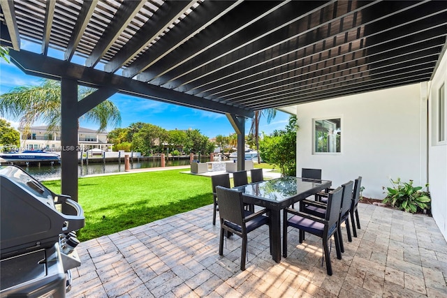 view of patio with a pergola and a water view