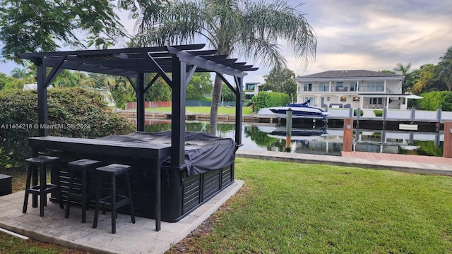 exterior space featuring a boat dock, a pergola, and a water view