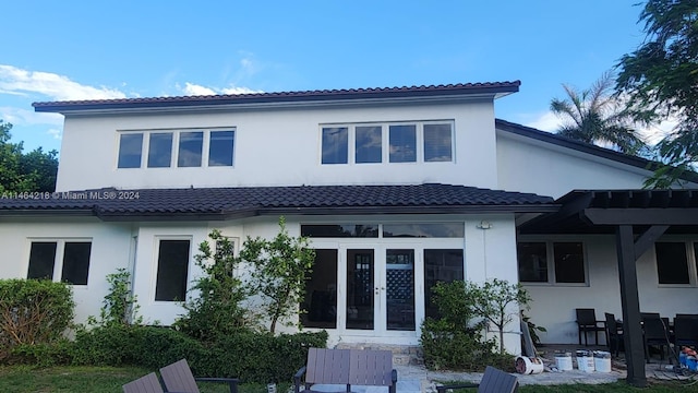 view of patio with a pergola and a water view