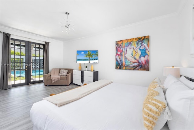 bedroom with access to outside, crown molding, hardwood / wood-style flooring, and french doors