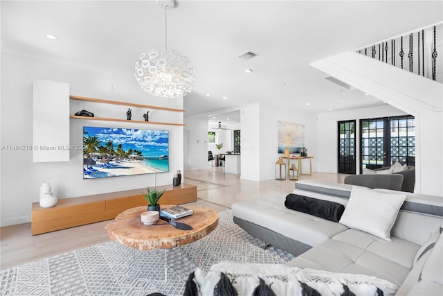 living room with a notable chandelier and crown molding