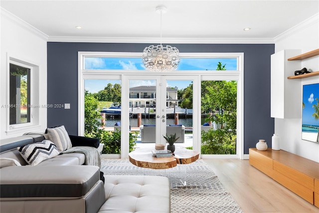 living room featuring light hardwood / wood-style floors, plenty of natural light, french doors, and a chandelier