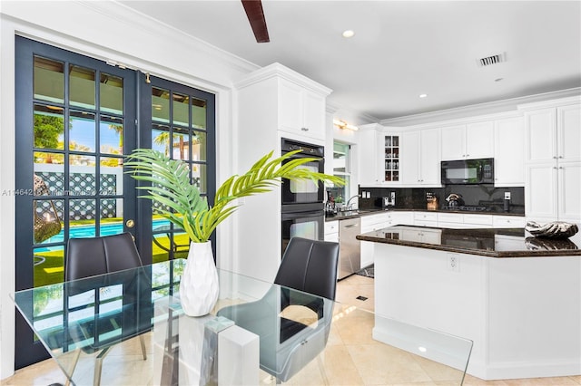 kitchen with backsplash, ornamental molding, light tile patterned floors, black appliances, and white cabinets