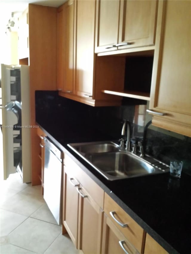 kitchen featuring sink, dishwasher, and light tile patterned floors