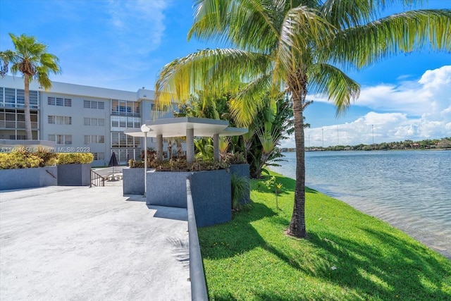 exterior space featuring a water view and a lawn