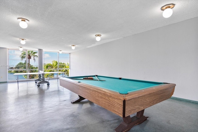 playroom featuring floor to ceiling windows, billiards, and a textured ceiling