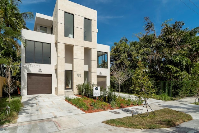 contemporary home featuring a balcony and a garage