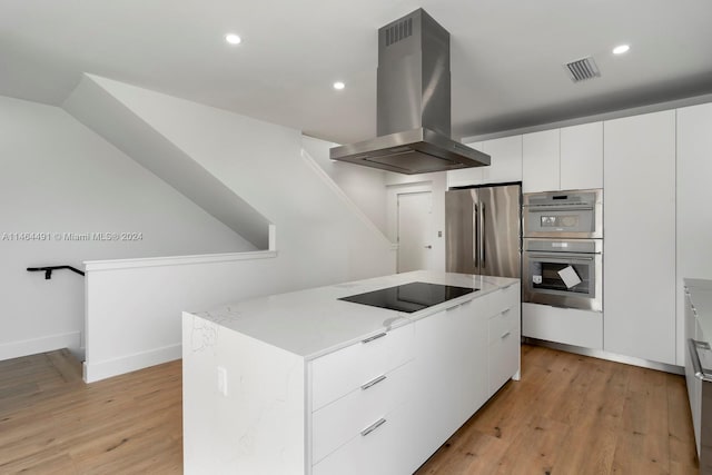 kitchen with light hardwood / wood-style floors, island exhaust hood, stainless steel appliances, and white cabinetry