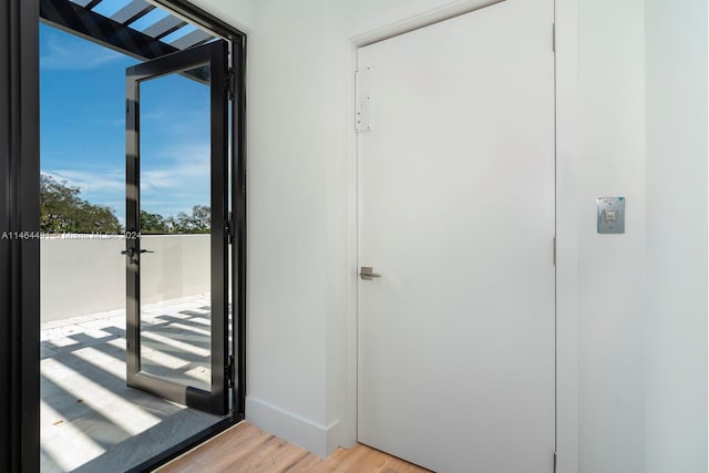 doorway with light wood-type flooring