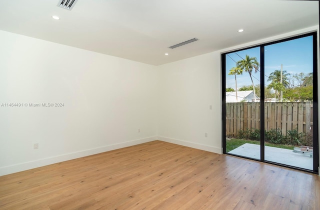 unfurnished room featuring floor to ceiling windows, a wealth of natural light, and light hardwood / wood-style flooring