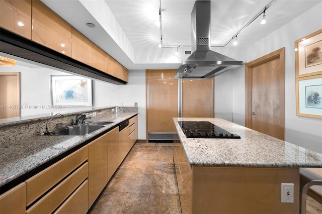 kitchen featuring island range hood, black gas stovetop, track lighting, light stone countertops, and tile flooring