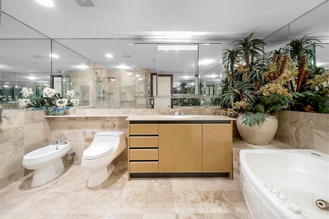 full bathroom featuring toilet, a bidet, vanity, tile walls, and tile flooring