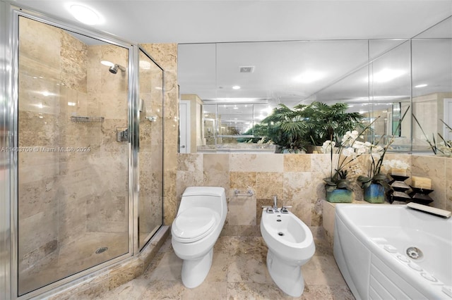 bathroom featuring tile walls, a bidet, tile floors, and toilet