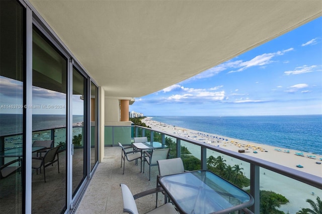 balcony with a water view and a beach view