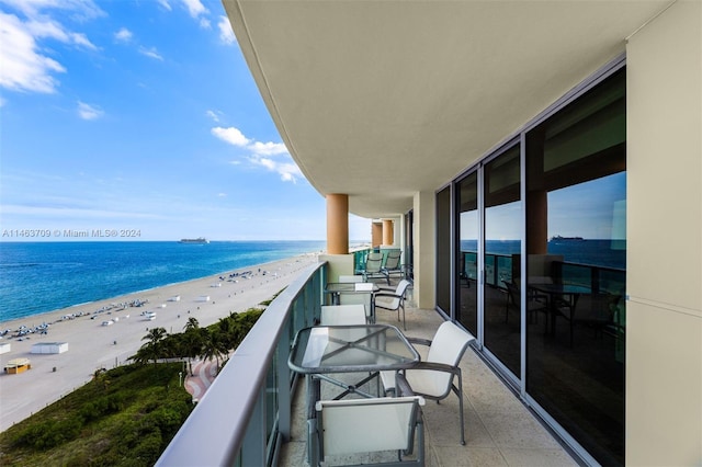 balcony with a beach view and a water view