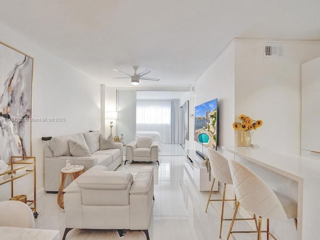 living room with light tile flooring and ceiling fan