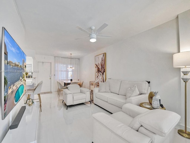 living room with ceiling fan with notable chandelier