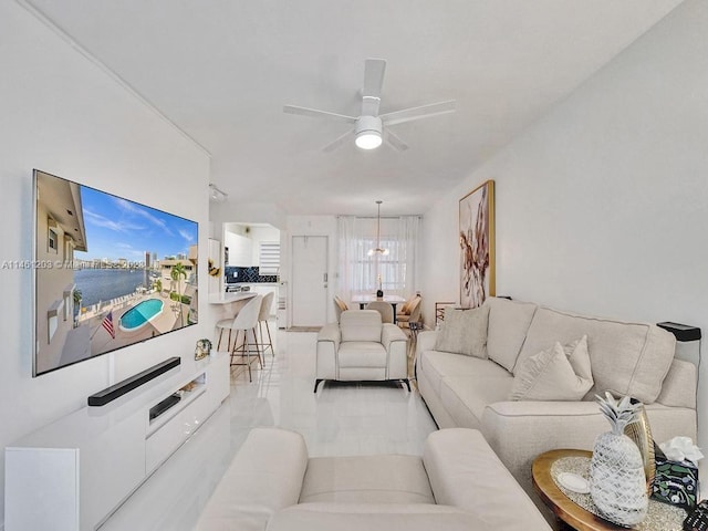 living room with light tile flooring and ceiling fan with notable chandelier