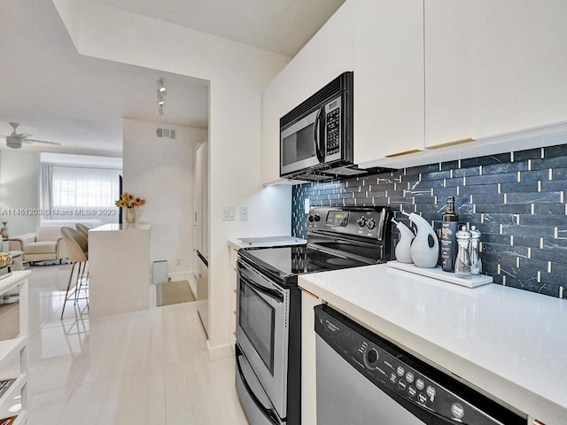 kitchen featuring white cabinets, backsplash, ceiling fan, and stainless steel appliances