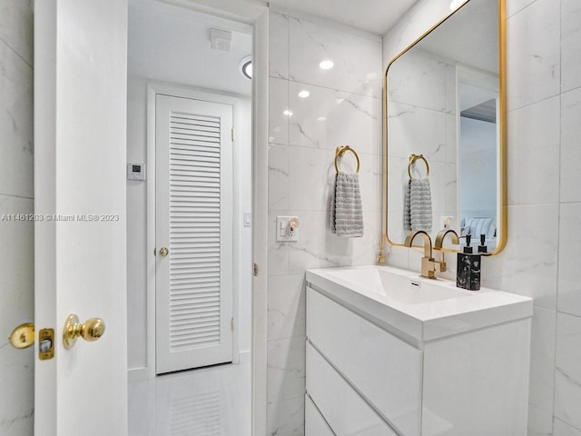 bathroom featuring tile walls and large vanity