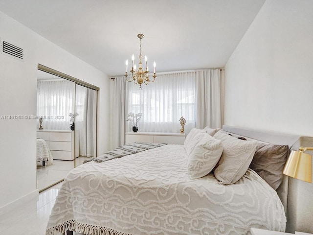 bedroom featuring light tile flooring, a closet, and an inviting chandelier