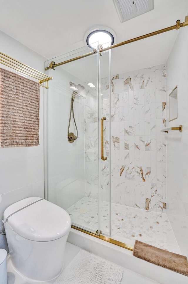 bathroom with walk in shower and toilet