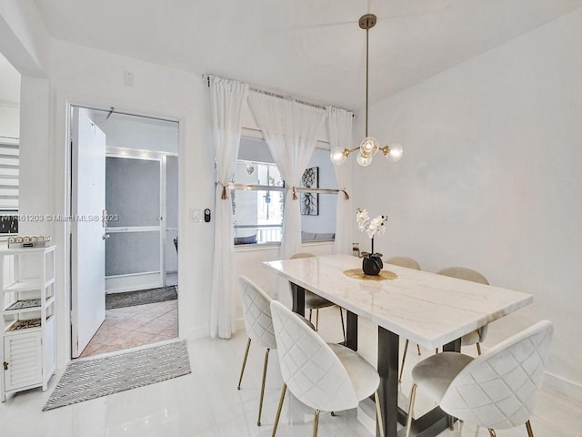 dining space with a notable chandelier and light tile floors