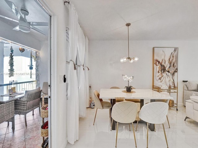 dining room with ceiling fan with notable chandelier and light tile floors