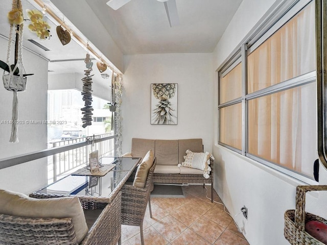 interior space with ceiling fan and light tile floors