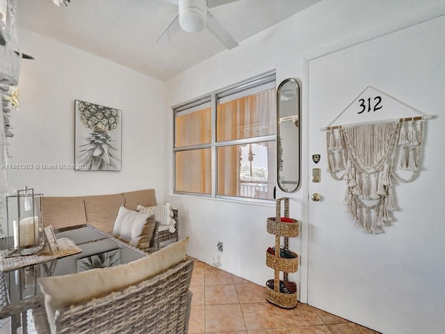 tiled living room featuring ceiling fan