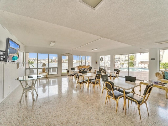 dining space featuring a textured ceiling and a wealth of natural light