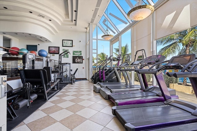 exercise room featuring light tile flooring