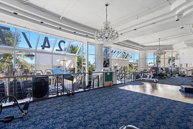 exercise room featuring a notable chandelier and carpet floors