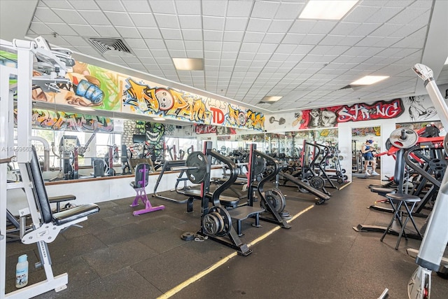 exercise room featuring a drop ceiling