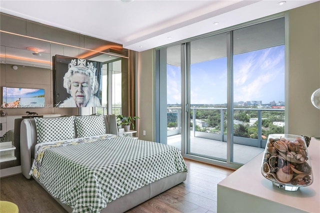 bedroom featuring floor to ceiling windows, hardwood / wood-style floors, and access to outside