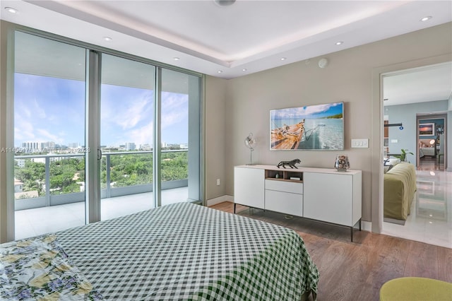 tiled bedroom featuring a wall of windows and access to exterior