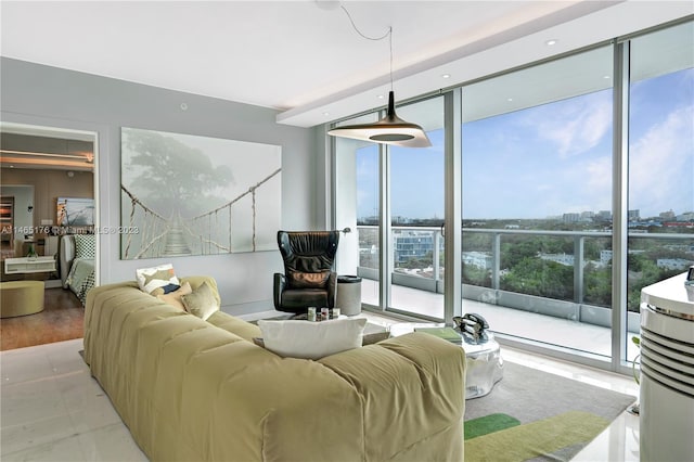 living room featuring floor to ceiling windows, a healthy amount of sunlight, and light hardwood / wood-style flooring