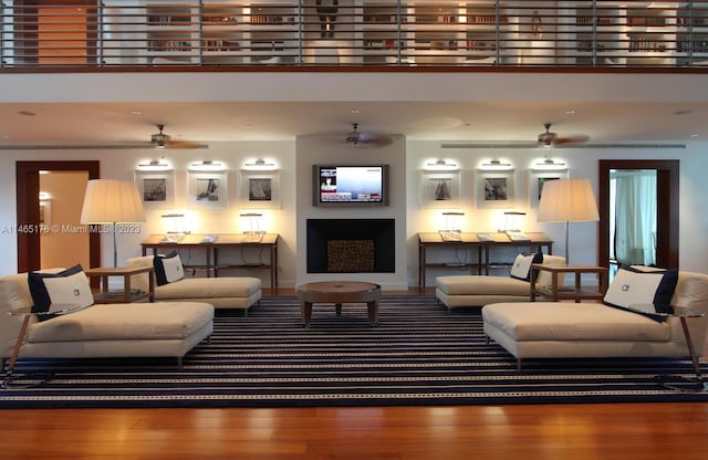 living room with ceiling fan and hardwood / wood-style flooring