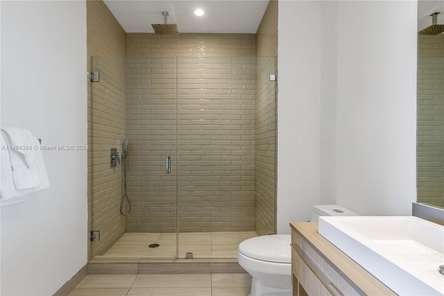 bathroom featuring walk in shower, tile flooring, toilet, and vanity