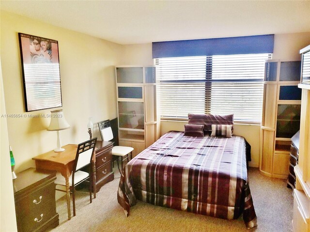 carpeted bedroom featuring multiple windows