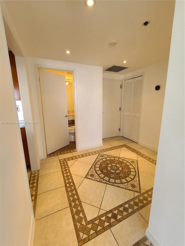 hallway featuring light tile floors