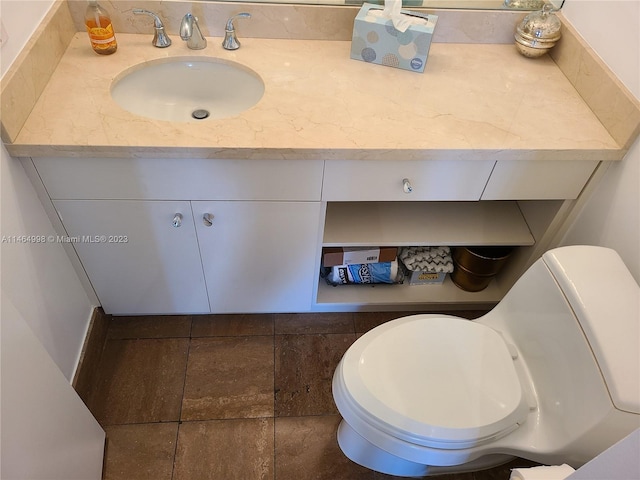 bathroom featuring toilet and vanity