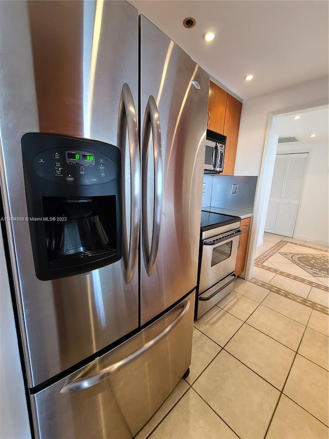 kitchen featuring appliances with stainless steel finishes and light tile flooring