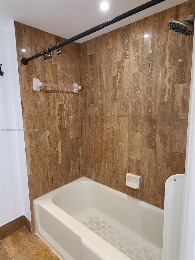 bathroom featuring tile floors and tiled shower / bath