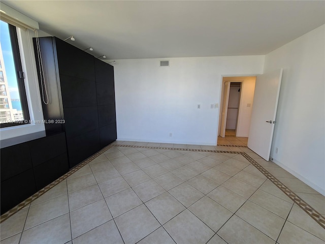 empty room with light tile floors