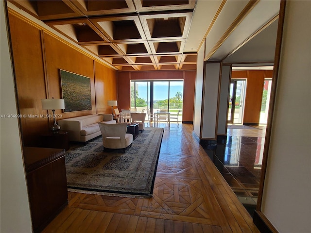 living room with ornamental molding, coffered ceiling, dark parquet floors, and beamed ceiling